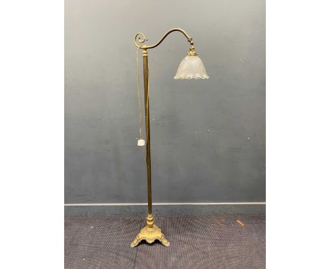 A 20th century brass floor lamp with reeded and scalloped glass drop shade, the brass support set on triform base, 165 x 36cm