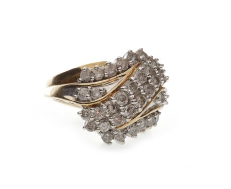 DIAMOND CLUSTER RING, the twist bezel with a central double row of diamonds in an S curve, on diamond shoulders, unmarked, si
