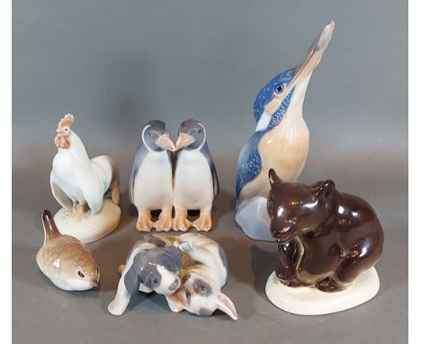 A Royal Copenhagen porcelain model of two Penguins together with three other Royal Copenhagen groups and a Russian model of a