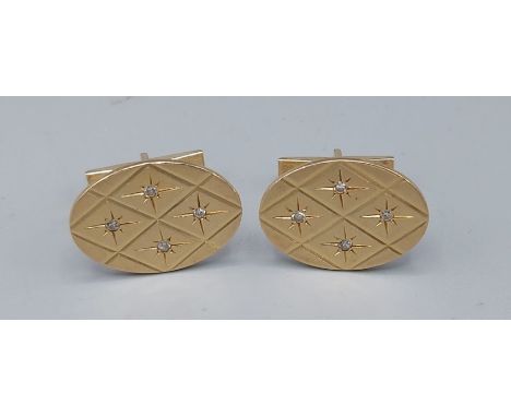 A pair of 14ct gold and Diamond set cufflinks, each set with four diamonds within engraved decoration, 1.9cms by 2.5cms, 16.7