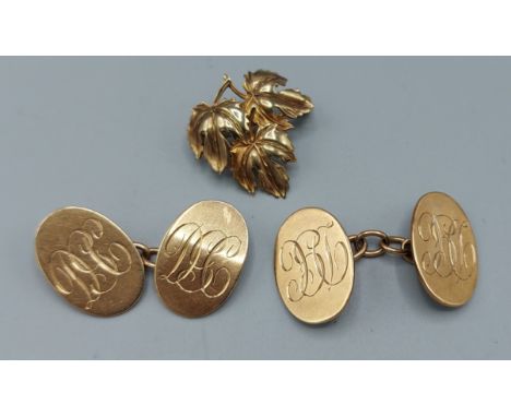 A pair of 9ct gold cufflinks together with a 9ct gold brooch of leaf form, 11.6gms 