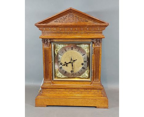 An early 20th Century oak mantle clock, the brass dial with Roman numerals and three train movement striking on a gong, 41cms