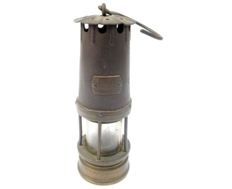 A brass and cast iron miner's lamp, bearing numbered plaque 1548, with ring handle, 24.5cm high. 