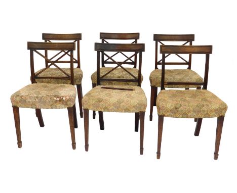 A set of six Regency mahogany dining chairs, with tapestry seats, raised on tapering square legs on spade feet.