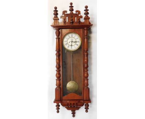 A 20thC walnut cased Vienna wall clock, with circular white enamel dial bearing Roman numerals, subsidiary seconds, eight day