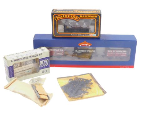 A Bachmann Branchline three Northern Co-op wagons, seven plank wagon, extra wheels, and a Peco OO gauge wagon kit. (a quantit