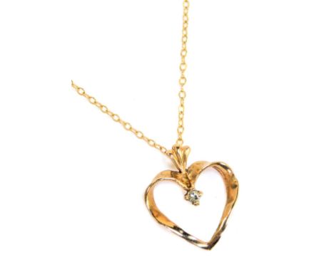 A 9ct gold heart shaped pendant and chain, the heart shaped pendant set with a tiny white stone, 1.4cm high, on fine link 9ct