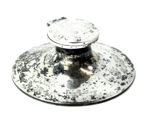 An Elizabeth II silver Capstan inkwell, with ceramic well, on a weighted and leatherette base, Birmingham 1971.