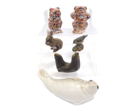 A Swedish pottery model of a reclining seal, 23cm wide, a Poole pottery bird on a leaf, 8cm high, and two Oriental style Imar
