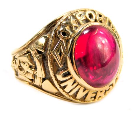 A 9ct gold replica Oxford University signet ring, with central cabochon cut ruby, and Oxford University motto and motif, ring