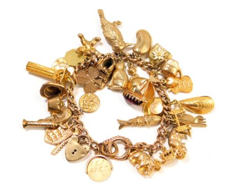 A 9ct gold gate bracelet, with a curb link bracelet and safety chain, heart shaped padlock and various charms to include a ca