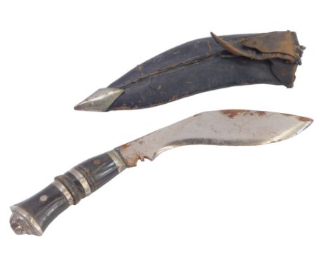 A Middle Eastern kukri sheath knife, with an ebonised and stainless steel handle, curved blade with leather scabbard, 26cm wi