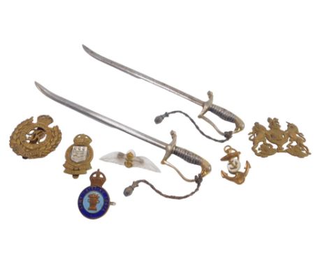 Militaria, comprising two ceremonial letter openers and various badges, one enamel set from the Army Catering Corps. 