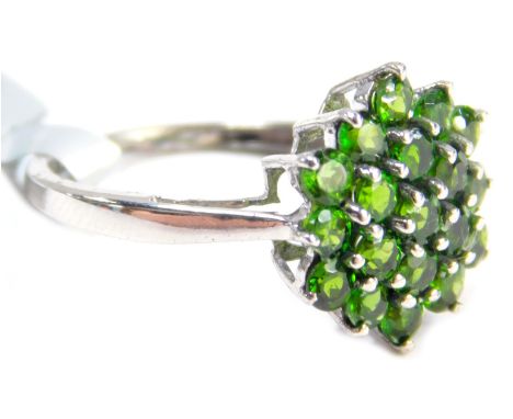 A Coloured Rocks dress ring, the cluster with central stone and two outer halos, set with pale green stones, on a white metal