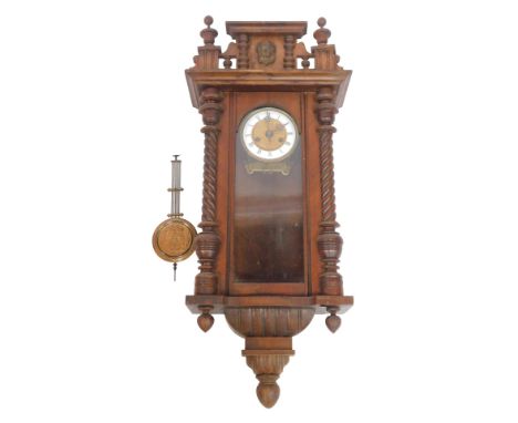 An early 20thC walnut cased Vienna wall clock, the brass dial with white enamel chapter ring bearing Roman numerals, eight da