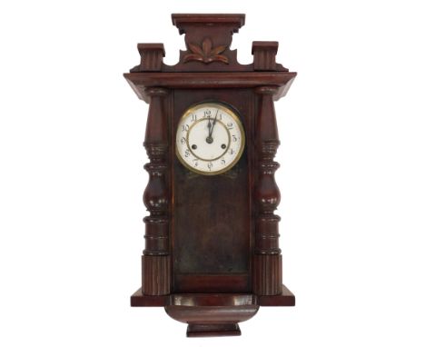 An early 20thC mahogany cased wall clock, the circular white enamel dial bearing Arabic numerals, eight day, 60cm high. 