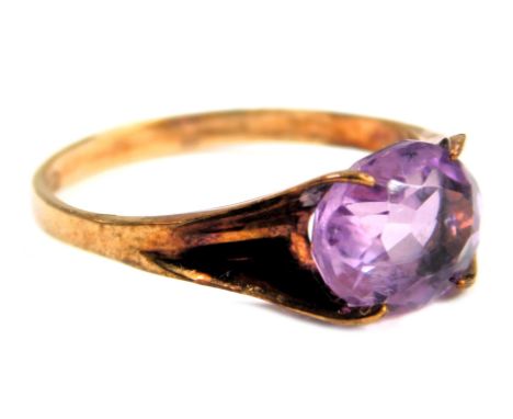 An amethyst dress ring, set with an oval amethyst, in a shaped four claw setting, with pierced and flowing shoulders, yellow 