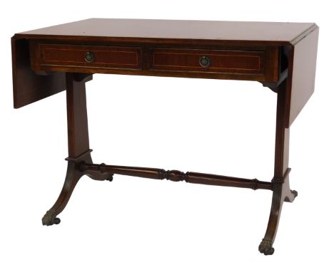 A 20thC mahogany and line inlaid Regency style sofa table, the drop leaf top above two frieze drawers, line carved end suppor