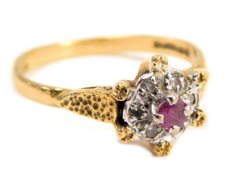 An 18ct gold ruby and diamond cluster ring, the central round brilliant cut ruby in a four claw setting, surrounded by six ti
