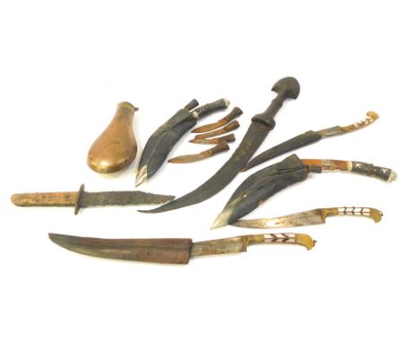 A group of Middle Eastern daggers, together with a dagger with wooden handle and curved blade, copper shot flask, etc. (1 box
