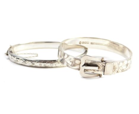 Two silver bangles, comprising a buckle hinged bangle by B Limited, Birmingham 1952, and a further silver hinged bangle, Birm