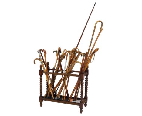 A 20thC oak stick stand, with three sections for sticks, with shaped end supports, on turned cylindrical feet, 75cm high, 78c