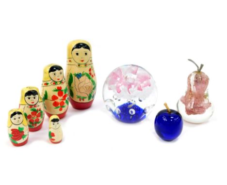 A group of glassware, comprising a globular paperweight with pink floral and bubble decoration, 15cm high, pear-shaped paperw