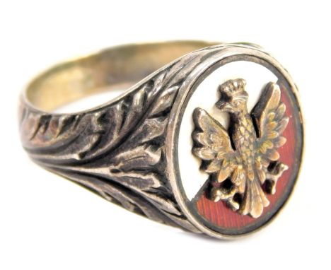 A signet ring, the oval crest with white and red enamel, and a raised grouse in a crown, with fern shoulders, white metal unm