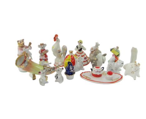 A group of Russian ceramics, to include a figure playing an accordion, a mouse and ball condiment pot and cover, cat figure, 