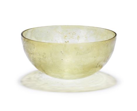  A Roman yellow glass hemispherical bowl with wheel-cut decoration Circa late 1st Century B.C – early 1st Century A.D.6.2cm h