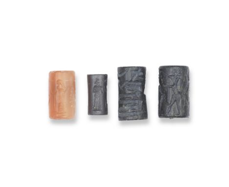  A Neo-Babylonian carnelian cylinder seal, an Old Babylonian haematite cylinder seal, an Akkadian black serpentine cylinder s
