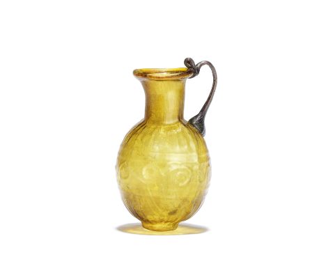  A Roman amber glass juglet with an aquamarine handle Circa mid-late 1st Century A.D.7.3cm high Footnotes:Provenance:with Jac