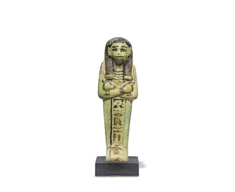  An Egyptian pale turquoise glazed faience shabti for the Overseer of the Gate, Hwy Ramesside, early 19th Dynasty, circa 1292