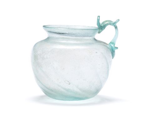  A Roman blue-green glass handled ribbed cup Western Empire, circa early 2nd Century A.D.10.5cm high Footnotes:Provenance:wit