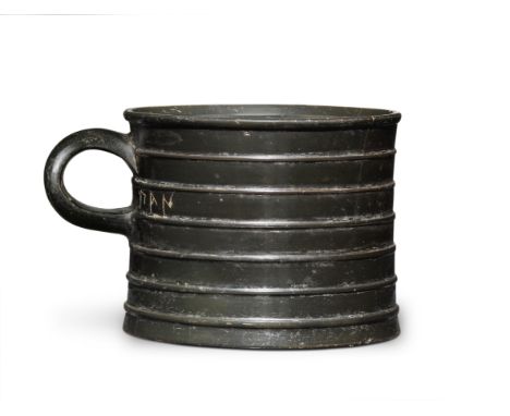  An Attic black-glazed mug with inscription  Circa early 5th Century B.C.7.1cm highFootnotes:Provenance:Frankurt art market.D