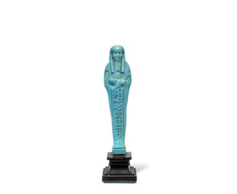  An Egyptian blue glazed faience shabti for the priest Psamtek-Mer-Ptah First Persian Period, 27th Dynasty, circa 525-380 B.C