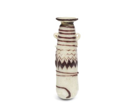  A Greek opaque white core-formed glass alabastron with purple decoration Circa late 6th-5th Century B.C.10.4cm high Footnote