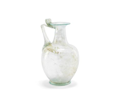  A Roman pale green glass jug Circa late 1st-early 2nd Century A.D.17.7cm high Footnotes:Provenance:Private collection, USA, 