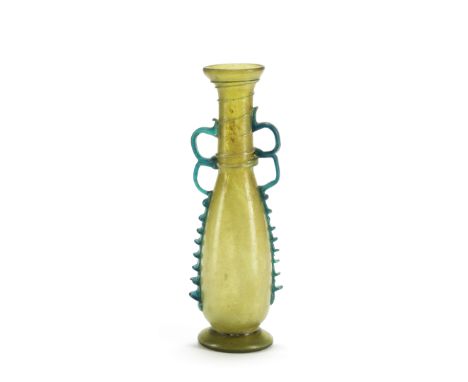  A Roman yellow-green glass flask with aquamarine handles and trails Circa 4th-5th Century A.D.20cm high Footnotes:Provenance