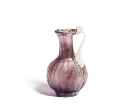  A Roman streaky aubergine glass mould-blown melon-shaped juglet with opaque white handle Circa late 1st Century A.D.7.8cm hi