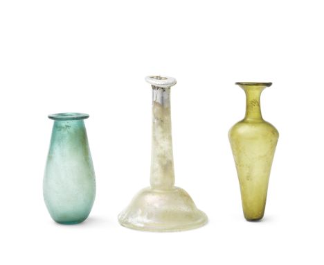  A Roman green glass jar, a Roman pale green glass candlestick unguentarium and a Roman yellow-green piriform glass flask Cir
