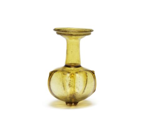  A Roman amber glass pomegranate-shaped sprinkler flask Circa early 4th Century A.D.11.8cm high Footnotes:Provenance:Anonymou