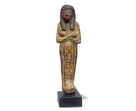  An Egyptian wood polychrome painted shabti for the Chief Guard of the Treasury of the Estate of Amun Ramesside, 19th-20th Dy