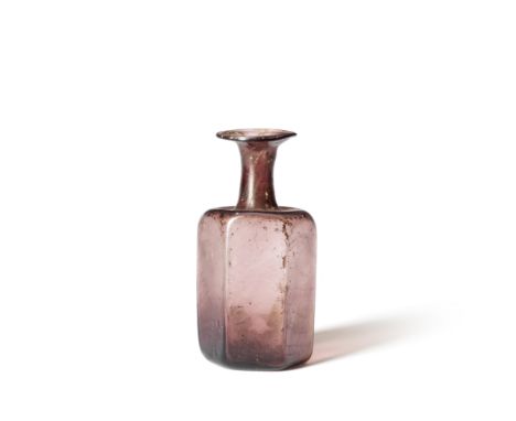  A Roman pale aubergine glass hexagonal flask Circa 2nd-4th Century A.D.11.7cm high Footnotes:Provenance: Anonymous sale; Chr