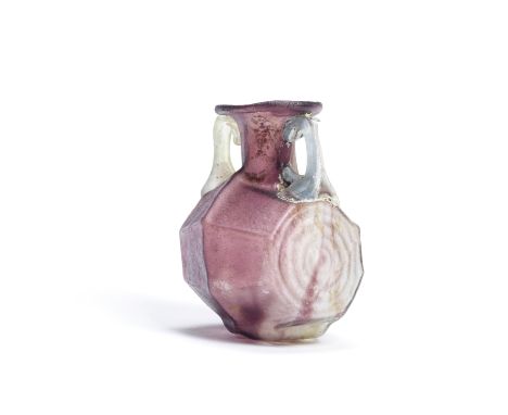  A Roman streaky aubergine glass multi-sided bottle with pale green and blue handles Circa late 1st-early 2nd Century A.D.6.4