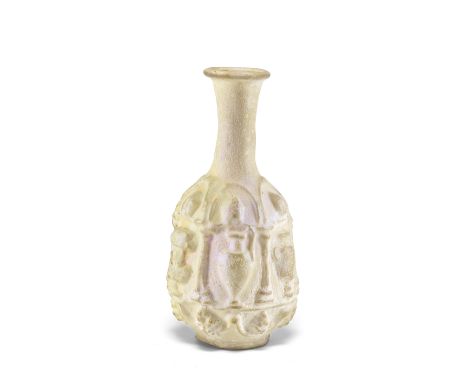  A Roman opaque white glass hexagonal bottle with vessels in relief Circa 1st Century A.D.8.3cm high Footnotes:Provenance:The