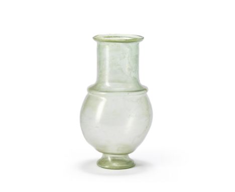  A Roman green glass footed bulbous flask Reputedly from Krefeld, the Rhineland, circa late 1st-2nd Century A.D.16.1cm high F