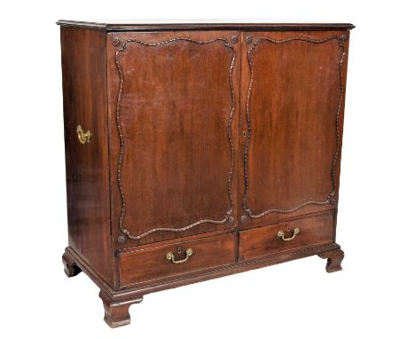 A Late George III Mahogany Dwarf Linen Press, early 19th century, the moulded top above cupboard doors enclosing four sliding