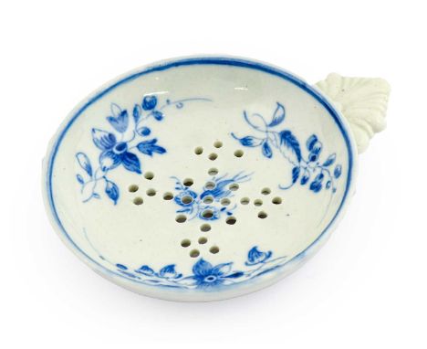 A Caughley Porcelain Egg Drainer, circa 1785, of circular form with leaf handle, painted in underglaze blue with flower sprig