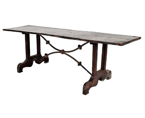 An 18th Century Spanish Walnut Dining Table, the one-piece top on square form supports with moulded bracket feet joined by C 